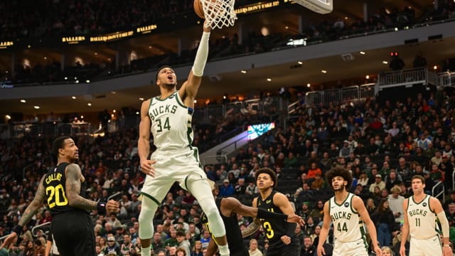 Milwaukee Bucks forward Giannis Antetokounmpo (34) scores a basket against Utah Jazz forward John Collins (20)